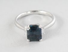A PLATINUM RADIANT GREEN SAPPHIRE RING, 2.77cts, with baguette diamond shoulders, 0.07cts.