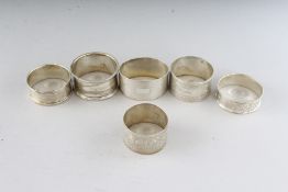 SIX VARIOUS SILVER SERVIETTE RINGS. Weight 4ozs.