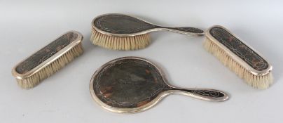 A SILVER AND TORTOISESHELL HAND MIRROR AND THREE BRUSHES. Birmingham 1919. Maker: LS for LEVI &