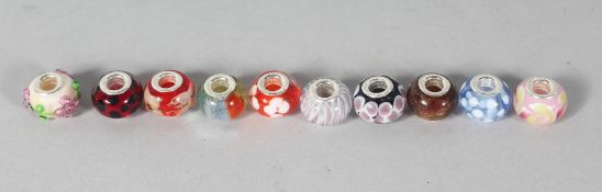 TEN VARIOUS ITALIAN GLASS AND SILVER CHARMS.