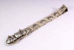 A RUSSIAN NIELLO DECORATED WHITE METAL BELT, consisting of an ornate buckle and fourteen oval