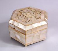 A 19TH CENTURY INDIAN MOTHER OF PEARL LIDDED BOX, the top with carved foliate design, 8cm wide.