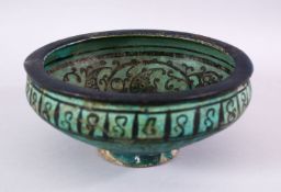 AN EARLY PERSIAN TURQUOISE POTTERY BOWL, decorated with floral motif, 19cm (af)