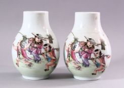 A PAIR OF CHINESE REPUBLICAN STYLE PORCELAIN VASES, each painted with scenes of playful treatment,