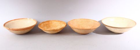 A GROUP OF FOUR EARLY CHINESE EARTHENWARE CIRCULAR BOWLS, various sizes.