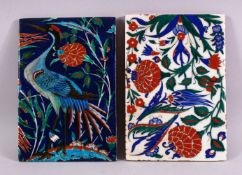 TWO IZNIK TILES, one painted with a heron, one with stylised flowers, both 24cm x 16cm.