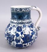 AN ISLAMIC BLUE & WHITE PORCELAIN WATER JUG, decorated ith formal scrolling flora, 20cm high.