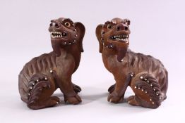 A GOOD PAIR OF CHINESE 19TH CENTURY TERRACOTTA FORMED LION DOG FIGURES, the mirrored pair with