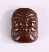 A JAPANESE MEIJI PERIOD BRONZE NOH MASK, with gilt eye decoration, 5.5cm high x 4cm