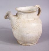 AN EARLY CHINESE POTTERY JUG, with floral decoration, 11cm high.