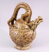 AN UNUSUAL TREACLE GLAZED POTTERY WINE EWER, with dragon handle and spout, 23cm high.