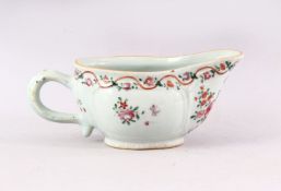 A 19TH CENTURY CHINESE FAMILLE ROSE SAUCEBOAT, painted with flowers, 19cm long.