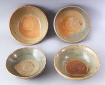 A GROUP OF FOUR EARLY CHINESE EARTHENWARE CIRCULAR BOWLS, various sizes.