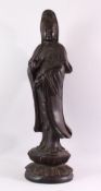 A LARGE 19TH / 20TH CENTURY CHINESE CARVED HARDWOOD FIGURE OF GUANYIN, stood upon a lotus base,