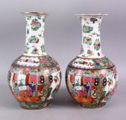 A PAIR OF 20TH CENTURY FAMILLE ROSE BALUSTER VASES, painted with figures in an interior, 30cm high.