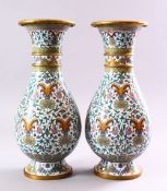 A PAIR OF CHINESE CLOISONNE BALUSTER SHAPE VASES, with floral sprays and lotus flowers, 31cm.