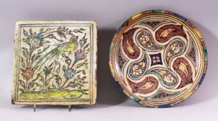 AN ISLAMIC GLAZED TILE, painted with a bird and flowers, 24.5cm x 24.5cm. together with an Eastern