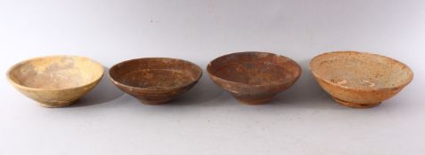 A GROUP OF FOUR EARLY CHINESE EARTHENWARE CIRCULAR BOWLS, various sizes.