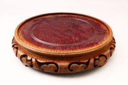 A GOOD 19TH CENTURY CHINESE CARVED HARDWOOD STAND, 25cm diameter housing a vase no larger than