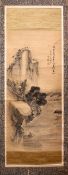 AN EARLY 20TH CENTURY CHINESE SCROLL PAINTING, with a fisherman in a boat on a lake beneath a