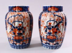 A PAIR OF JAPANESE MEIJI PERIOD IMARI PORCELAIN VASES, decorated with panels of ikebana and