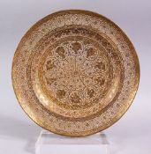 A GOOD INDIAN PIERCED GILDED WHITE METAL CIRCULAR DISH, 23cm diameter.