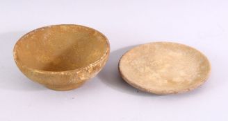 A SMALL CHINESE POTTERY BOWL AND STAND, with incised decoration, 11cm diameter.