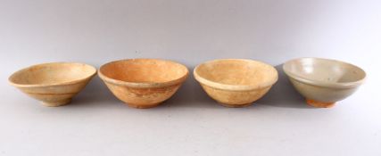 A GROUP OF FOUR EARLY CHINESE EARTHENWARE CIRCULAR BOWLS, various sizes.