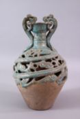 A CHINESE TANG STYLE CELEDON GLAZED DOUBLE WALLED BOTTLE VASE, with dragon handles, 27cm.