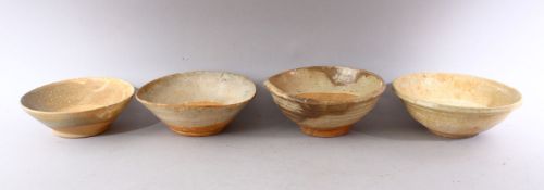 A GROUP OF FOUR EARLY CHINESE EARTHENWARE CIRCULAR BOWLS, various sizes.