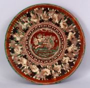 A 19TH CENTURY OR EARLIER INDIAN POTTERY DISH, with poly chrome decoration depicting a multi