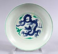 A CHINESE FAMILLE VERTE / DOUCAI PORCELAIN DRAGON DISH, with a five claw dragon amongst clouds,