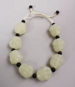 A SET OF CHINESE CARVED CELADON JADE BEAD BRACELETS, the beads carved in the form of buddhas faces