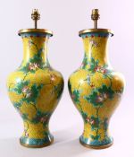 A PAIR OF CHINESE CLOISONNE VASES, with yellow ground and lotus flowers, converted into lamps,
