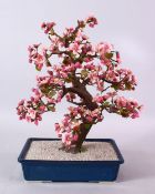 A JAPANESE CARVED HARD STONE FIGURE OF A BONSAI, depicting a cherry blossom tree, 42cm high x 25cm