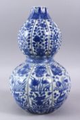 A CHINESE MING STYLE BLUE & WHITE DOUBLE GOURD, with a ribbed section body, with scenes of phoenix