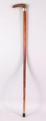 A LATE 19TH CENTURY RHINO HANDLED WALKING STICK, with engraved silver collar, 84cm long.