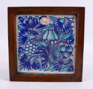 A GOOD FRAMED TURKISH POTTERY TILE, decorated with two tone blue fruit and vine decoration, 23cm
