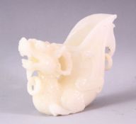 A 20TH CENTURY CHINESE CARVED WHITE JADE LIBATION CUP OF A LION DOG, 14cm high.