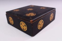 A JAPANESE LACQUER BOX AND COVER, decorated with circular mon, 22cm x 20cm.