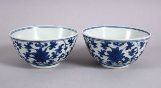 A PAIR OF CHINESE BLUE & WHITE MING STYLE PORCELAIN RICE BOWLS, each decorated with formal scrolling
