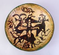 A GOOD EARLY ISLAMIC POTTERY DISH, decorated with animals (AF), 33cm,