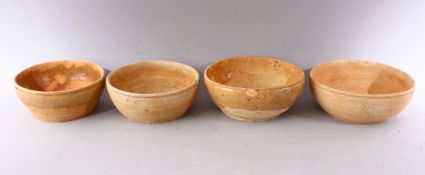 A GROUP OF FOUR EARLY CHINESE EARTHENWARE CIRCULAR BOWLS, various sizes.