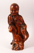 A CHINESE CARVED ROOTWOOD FIGURE OF A SAGE, 29cm high.