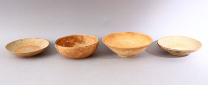 A GROUP OF FOUR EARLY CHINESE EARTHENWARE CIRCULAR BOWLS, various sizes.