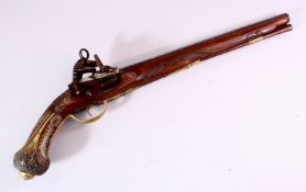 AN 18TH CENTURY INDIAN FLINTLOCK PISTOL, with silver inlaid barrel, well carved wooden stock with
