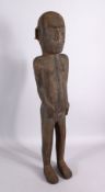 AN AFRICAN CARVED WOODEN NATIVE FIGURE, with piercing's, 80cm.
