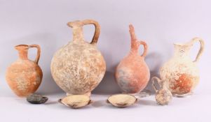 A SMALL COLLECTION OF EXCAVATED POTTERY ITEMS, comprising four teracotta jugs, two small twin handle