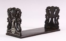A CEYLONESE EBONY FOLDING BOOK STAND, with carved bone inlaid decoration, 35cm long.