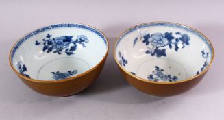 A PAIR OF CHINESE NANKING CARGO SHIPWRECK BOWLS, the interior with blue and white floral decoration,
